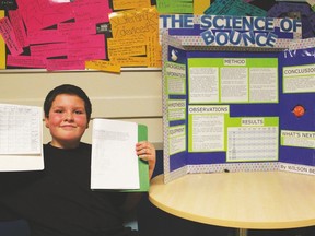 Tomahawk School student Wilson Bell sits beside his science fair project after being judged for a Regional competition on February 23rd.