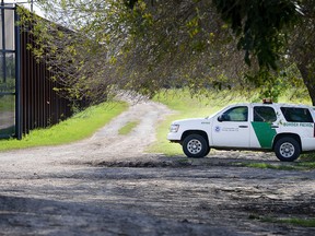 A U.S. Border Patrol agent guards a fence gate along the U.S.-Mexico border, Thursday, Feb. 16, 2017, in Brownsville, Texas. (Jason Hoekema/The Brownsville Herald via AP)