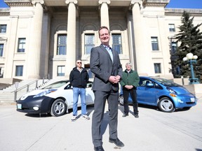NDP MLA Rob Altemeyer stands in front of Bill Rossington (left) and Ross Redman at the Manitoba Legislature, in Winnipeg. Two electric cars were present, Altemeyer, NDP Environment critic, talked about putting electric cars and busses on Manitoba roads . Friday, February 24, 2017. Chris Procaylo/Winnipeg Sun/Postmedia Network