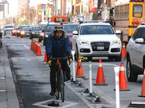A cyclist uses the Bloor St. bikes lanes during the morning rush hour east of Bathurst St. on Thursday, Feb. 3, 2017. (MICHAEL PEAKE/TORONTO SUN)