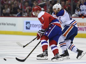 Edmonton Oilers right wing Zack Kassian (44) chases down Washington Capitals defenseman Dmitry Orlov (9), of Russia, for the puck during first period of an NHL hockey game, Friday, Feb. 24, 2017, in Washington.