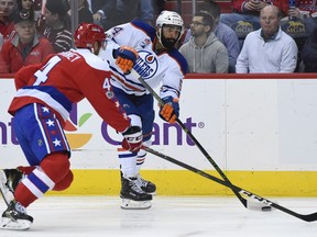 Edmonton Oilers left wing Jujhar Khaira (54) is pressured by Washington Capitals defenseman Taylor Chorney (4) during the first period of an NHL hockey game, Friday, Feb. 24, 2017, in Washington.