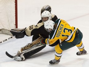 U of A Pandas' Amy Boucher (13) scores on Manitoba Bisons goaltender Rachel Dyck (56) during the first Canada West semi-final game at Clare Drake Arena at the University of Alberta in Edmonton on Friday, February 24, 2017.