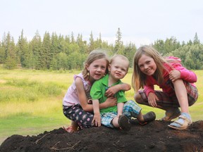 Three kids play in dirt.(Anne-Marie VanderVaart)