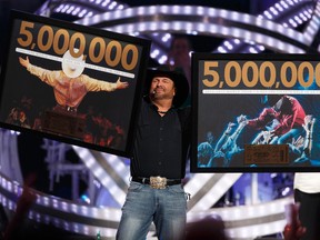 Garth Brooks celebrates the 5 millionth Garth Brooks ticket sold during his 2017 tour on stage at Rogers Place in Edmonton on Friday, February 24, 2017. (Ian Kucerak)
