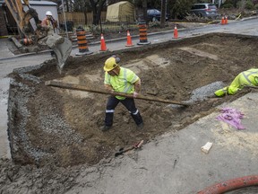 A crew works to fix a sinkhole on Morningside Ave. in High Park on Saturday, February 25, 2017. (Craig Robertson/Toronto Sun)
