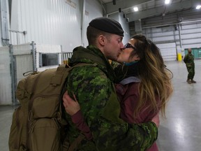 Master Cpl. Dennis Martens gives his wife Amanda a kiss after returning on Friday February 24, 2017 from a six month deployment on Operation Reassurance in Poland. GREG SOUTHAM / EDMONTON JOURNAL