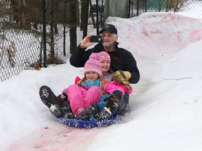 Vince Doyle and his six-year-old twin daughters, Ashlyn and Sophia, fly down the Doyle Lively luge at their home in Lively, Ont. on Saturday February 25, 2017. John Lappa/Sudbury Star/Postmedia Network