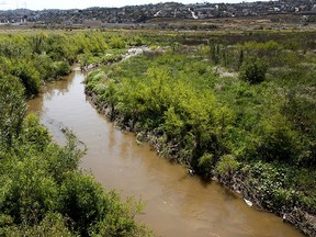 In this April 12, 2012, file photo, the Tijuana River flows near Dairy Mart Road in San Ysidro, Calif.   (Howard Lipin/The San Diego Union-Tribune via AP, File)