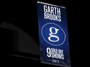 A Garth Brooks banner is revealed in the rafters during a special presentation for the 5 millionth Garth Brooks ticket sold on stage at Rogers Place in Edmonton on Friday, February 24, 2017.