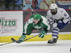 Dmitry Sokolov of the Sudbury Wolves gets taken down by Marcus Dickerson of the Mississauga Steelheads during OHL action from the Sudbury Community Arena on Saturday night.Gino Donato/The Sudbury Star
