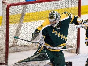 University of Alberta Golden Bears Brendan Burke makes a save against the University of Calgary Dinos during Canada West semi-final game 2 action on Saturday February 25, 2017 at Clare Drake Arena in Edmonton.