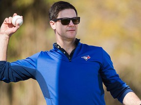 Toronto Blue Jays general manager Ross Atkins throws a ball during baseball spring training in Dunedin, Fla., on Sunday, Feb. 19, 2017. THE CANADIAN PRESS/Nathan Denette
