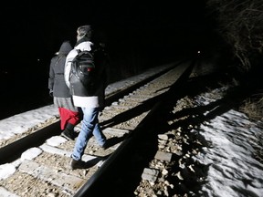 Early on Feb. 26, migrants from Somalia cross into Canada illegally from the United States. They walked down a train track into the town of Emerson, Man., to seek asylum at Canada Border Services Agency. (THE CANADIAN PRESS)