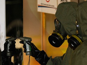 A Hazmat crew checks a stain on the wall at Kuala Lumpur International Airport 2 in Sepang, Malaysia on Sunday, Feb. 26, 2017.  (AP Photo/Daniel Chan)