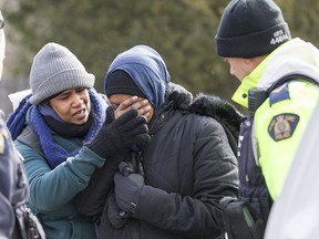 Two women from Sudan became emotional while being detained by the RCMP after they illegally crossed the Canada-U.S. border near Hemmingford, Que., on Feb. 26. (AFP PHOTO)
