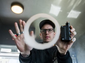 Vape store employee Matthew Krawchuk makes a ring from the vapour produced by dripping on Feb. 16. (ERNEST DOROSZUK, Toronto Sun)_