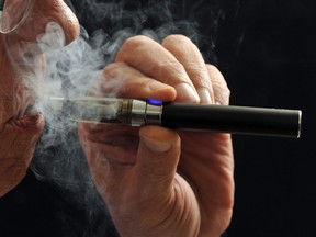 In this Jan. 17, 2014 file photo, a smoker demonstrates an e-cigarette in Wichita Falls, Texas. (AP Photo/Wichita Falls Times Record News, Torin Halsey, File)