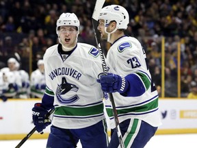 Vancouver Canucks defenseman Alexander Edler, of Sweden, celebrates with Ben Hutton after Edler scored a goal against the Nashville Predators during the third period of an NHL hockey game Tuesday, Feb. 7, 2017, in Nashville, Tenn. (AP Photo/Mark Humphrey)