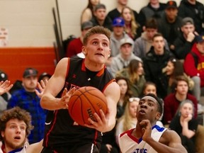 Noah Lapierre, middle, of Lasalle Lancers, goes up for a shot during the senior boys basketball NOSSA final against Sudbury Secondary School on Saturday evening at Lasalle Secondary School. John Lappa/Sudbury Star