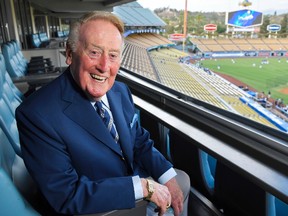 Hall of Fame broadcaster Vin Scully poses for a photo prior a baseball game between the Los Angeles Dodgers and the San Francisco Giants in Los Angeles on Sept. 20, 2016.