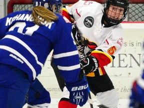 Inferno defender Katelyn Gosling passes the puck into the slot as the Calgary Inferno took on the Toronto Furies at the Winsport sportsplex in Calgary, Alta., on February 25, 2017. The Inferno won the game 3-1. They defeated the Furies again 3-1 on Sunday to claim the semifinal series.