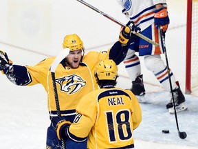 Nashville Predators left wing Viktor Arvidsson (38), of Sweden, celebrates with right wing James Neal (18) after Arvidsson scored a goal against the Edmonton Oilers during the third period of an NHL hockey game, Sunday, Feb. 26, 2017, in Nashville, Tenn. At right is Edmonton Oilers defenseman Matt Benning. The Predators won 5-4.