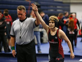 In this Feb. 18, 2017 photo, Euless Trinity's Mack Beggs is announced as the winner of a semifinal match after Beggs pinned Grand Prairie's Kailyn Clay during the finals of the UIL Region 2-6A wrestling tournament at Allen High School in Allen, Texas. Beggs, (Nathan Hunsinger/The Dallas Morning News via AP)