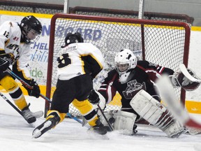 Drew Scherbarth (left) and Connor MacLean (8) of the Mitchell Pee Wees are thwarted on this scoring attempt against South Huron Sunday in Game 3 of their OMHA ‘CC’ semi-final series. The visitors stayed alive with a 4-1 win but trail the best-of-five series 2-1 with Game 4 tonight (Wednesday) in Exeter. ANDY BADER/MITCHELL ADVOCATE