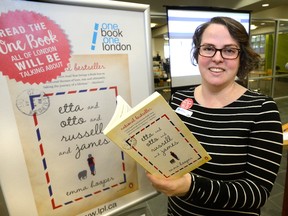 Information services librarian Kristen Caschera holds a copy of Etta and Otto and Russell and James by author Emma Hooper, the choice for the One Book One London program. (MORRIS LAMONT, The London Free Press)