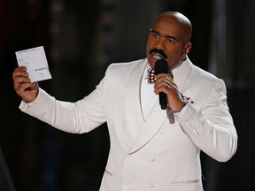 In this Dec. 20, 2015, file photo, Steve Harvey holds up the card showing the winners after he incorrectly announced Miss Colombia Ariadna Gutierrez at the winner at the Miss Universe pageant in Las Vegas. After an apparent envelope mix-up led Beatty and co-presenter Faye Dunaway to hand out the Oscars' best picture award to “La La Land” instead of the real winner, “Moonlight,” on Feb. 26, 2017, Harvey tweeted: “Call me Warren Beatty. I can help you get through this!” (AP Photo/John Locher, File)