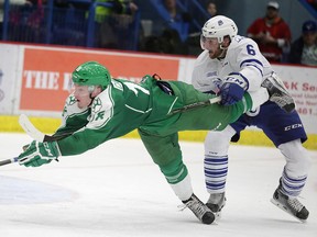 Sudbury Wolves forward Macauley Carson stretches for a puck while being hauled down against the Mississauga Steelheads at Sudbury Community Arena on Saturday. The Wolves were supposed to play a rubber match against the Steelheads on Sunday but the game was cancelled and has been rescheduled for the end of the regular season. Gino Donato/The Sudbury Star