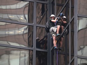 A man later identified as Stephen Rogata scales the all-glass facade of Trump Tower in New York using suction cups on Aug. 10, 2016. He pleaded guilty to reckless endangerment and disorderly conduct on Monday, Feb. 27, 2017. (Julie Jacobson/AP Photo)