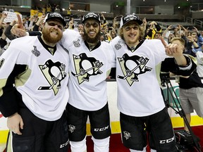 Phil Kessel, Nick Bonino and Carl Hagelin of the Pittsburgh Penguins celebrate after their 3-1 victory to win the Stanley Cup against the San Jose Sharks in Game 6 of the Stanley Cup Final at SAP Center on June 12, 2016. (Bruce Bennett/Getty Images)