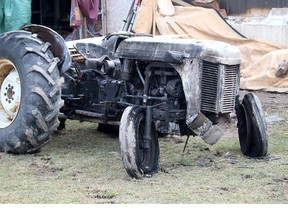 Relatives say Kevin Allison suffered severe burns and is clinging to life in a Hamilton, Ont. hospital after this tractor flipped over on him and caught fire while he was using the vehicle to pull out at post behind his home in Chatham, Ont. on Monday February 27, 2017. (Ellwood Shreve/Chatham Daily News/Postmedia Network)