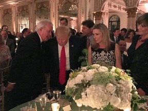 Former prime minister Brian Mulroney talks with U.S. President Donald Trump in Palm Beach, Fla., Feb.18, 2017. Mulroney apparently sang to Trump at the Mar-a-Lago in Florida Saturday night. A video posted on social media that appeared to be taken from a fundraising event shows Mulroney singing "When Irish Eyes are Smiling" after Canadian songwriter David Foster invited the former prime minister to the stage. (THE CANADIAN PRESS/Palm Beach Daily News-Shannon Donnelly)