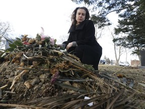 Andrea Murphy at her mother's recent grave in Riverside Cemetery in Etobicoke. (MICHAEL PEAKE, Toronto Sun)
