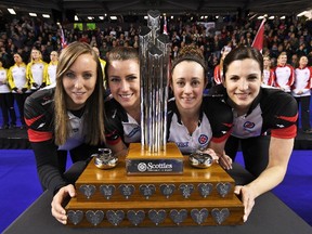 From left: Ontario skip Rachel Homan, third Emma Miskew, second Joanne Courtney and lead Lisa Weagle pose with the trophy after defeating Manitoba to win Scotties gold on Sunday. (The Canadian Press)