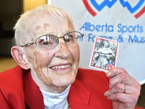 Holding a copy of her 1945 baseball card from the All American Girls Professional Baseball League on Monday, Feb. 27, 2017, Betty Carveth Dunn, 91, will be one of 11 athletes, along with one team, to get inducted into the Alberta Sports Hall of Fame this year, which is its 60th anniversary. (Ed Kaiser)