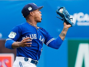 Toronto Blue Jays starting pitcher Marcus Stroman makes a leaping catch to put out Pittsburgh Pirates third baseman David Freese during spring training action in Dunedin on Feb. 27, 2017. (THE CANADIAN PRESS/Nathan Denette)