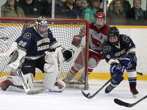 Notre Dame Alouettes defenceman Jaymes Green defelects the puck in front of goalie DJ Leblond during boys high school city championship action against the St. Charles Cardinals. Notre Dame swept St. Charles in 3 games to clain the championship. Gino Donato/The Sudbury Star