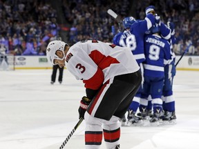 Ottawa Senators' Marc Methot reacts as members of the Tampa Bay Lightning celebrate a goal during an NHL game on Feb. 27, 2017. (AP Photo/Mike Carlson)