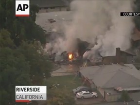 A small plane crashed into two homes in Riverside, Calif., Monday evening shortly after taking off from a nearby airport. (AP screengrab)