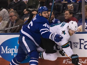 Toronto Maple Leafs defenceman Roman Polak crunches San Jose Sharks centre Joe Pavelski in Toronto on Dec. 13, 2016. (Craig Robertson/Toronto Sun)