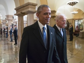 President Barack Obama and Vice President Joe Biden walk through the Crypt of the Capitol for Donald Trump's inauguration ceremony, in Washington, January 20, 2017. (Photo by J. Scott Applewhite - Pool/Getty Images)