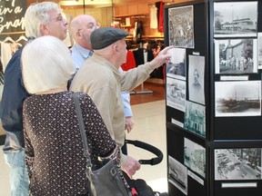 A group of Lambton Mall patrons examine the Sarnia Heritage Committee's vast collection of historical photographs on Feb. 23, part of the committee's annual display celebrating Ontario Heritage Week.
CARL HNATYSHYN/SARNIA THIS WEEK