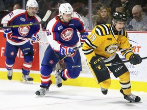 Ryan McGregor, right, of Sarnia Sting steps in front of Windsor Spitfires Luke Boka, right, and Aaron Luchuk, behind, in OHL first-period action from WFCU Centre on Sunday afternoon. The Sting won the contest 4-2. Sarnia now faces the Flint Firebirds on Wednesday evening at the Progressive Auto Sales Arena. (NICK BRANCACCIO/Windsor Star)