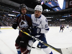 Tampa Bay Lightning centre Brian Boyle checks Colorado Avalanche defenceman Mark Barberio during an NHL game on Feb. 19, 2017. (AP Photo/David Zalubowski)