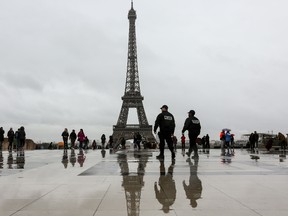 Two policemen patrol on the Trocadero square in front of the Eiffel tower on Febuary 28, 2017, in Paris. (LUDOVIC MARIN/Getty Images)