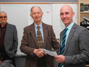 Principal Michael Blackburn, right, of Molly Brant Elementary School accepts a cheque donation of $995 from David Smith, president of the Kingston Musicians' Union Local 518, Canadian Federation of Musicians, from the Dick Baldwin Memorial fund to be put towards the school instrumental music program. (Julia McKay/The Whig-Standard)